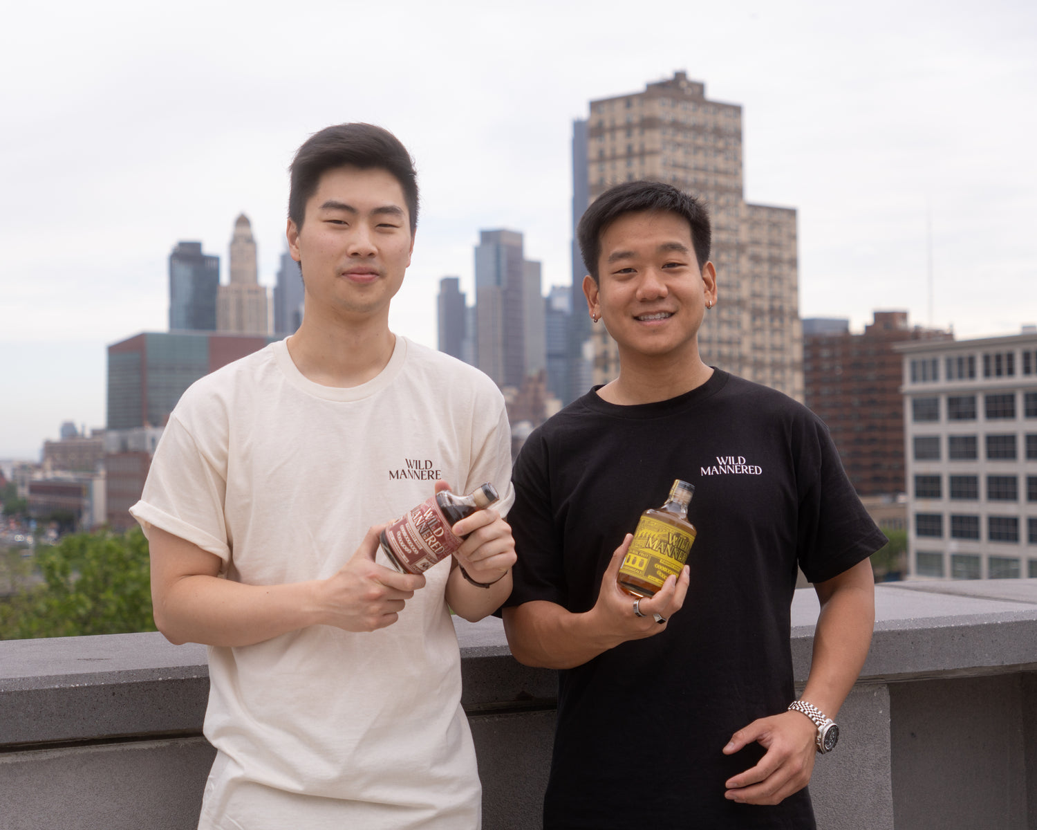 Co-founders Perry Ya and Michael Gu holding Wild Mannered all-natural soju cocktails in New York City