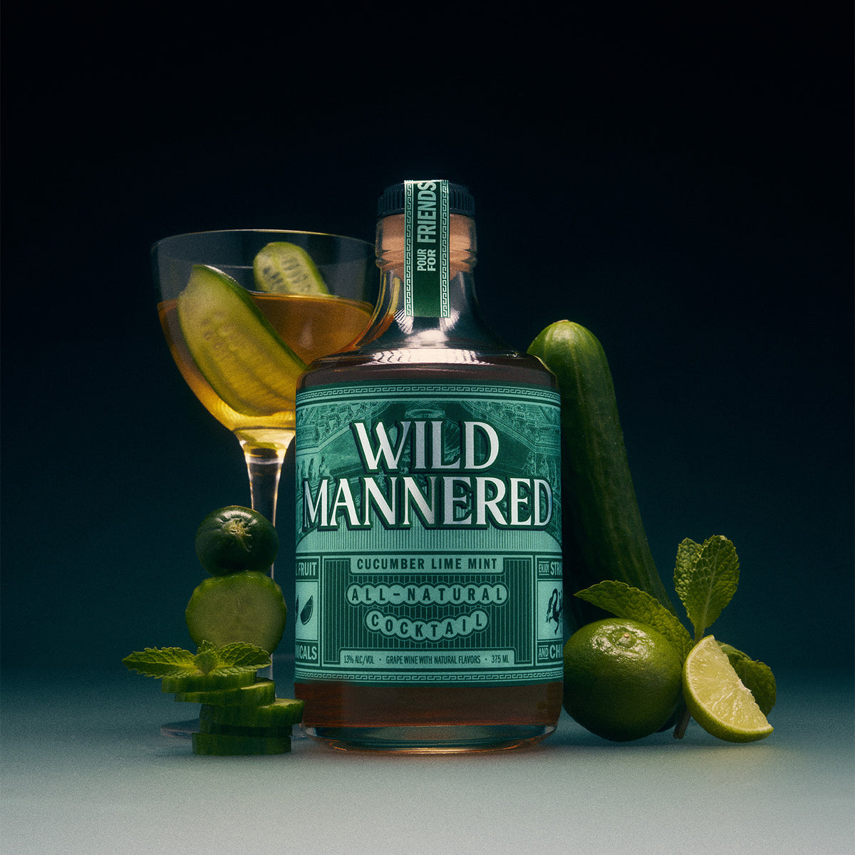 375 ml bottle of Cucumber Lime Mint Wild Mannered all-natural cocktail with cocktail glass, cucumbers, lime and mint 